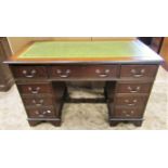 A reproduction Georgian style mahogany veneered kneehole twin pedestal desk with green inset leather