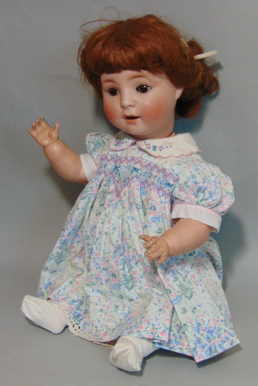 Schoenau & Hoffmeister bisque head baby doll with brown closing eyes, open mouth with teeth, brown