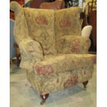 A substantial contemporary Georgian style wing armchair with upholstered finish and loose T shaped