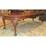 An Edwardian mahogany wind-out D end extending dining table with gadrooned border and three