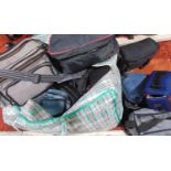 A large collection of camera bags and related items