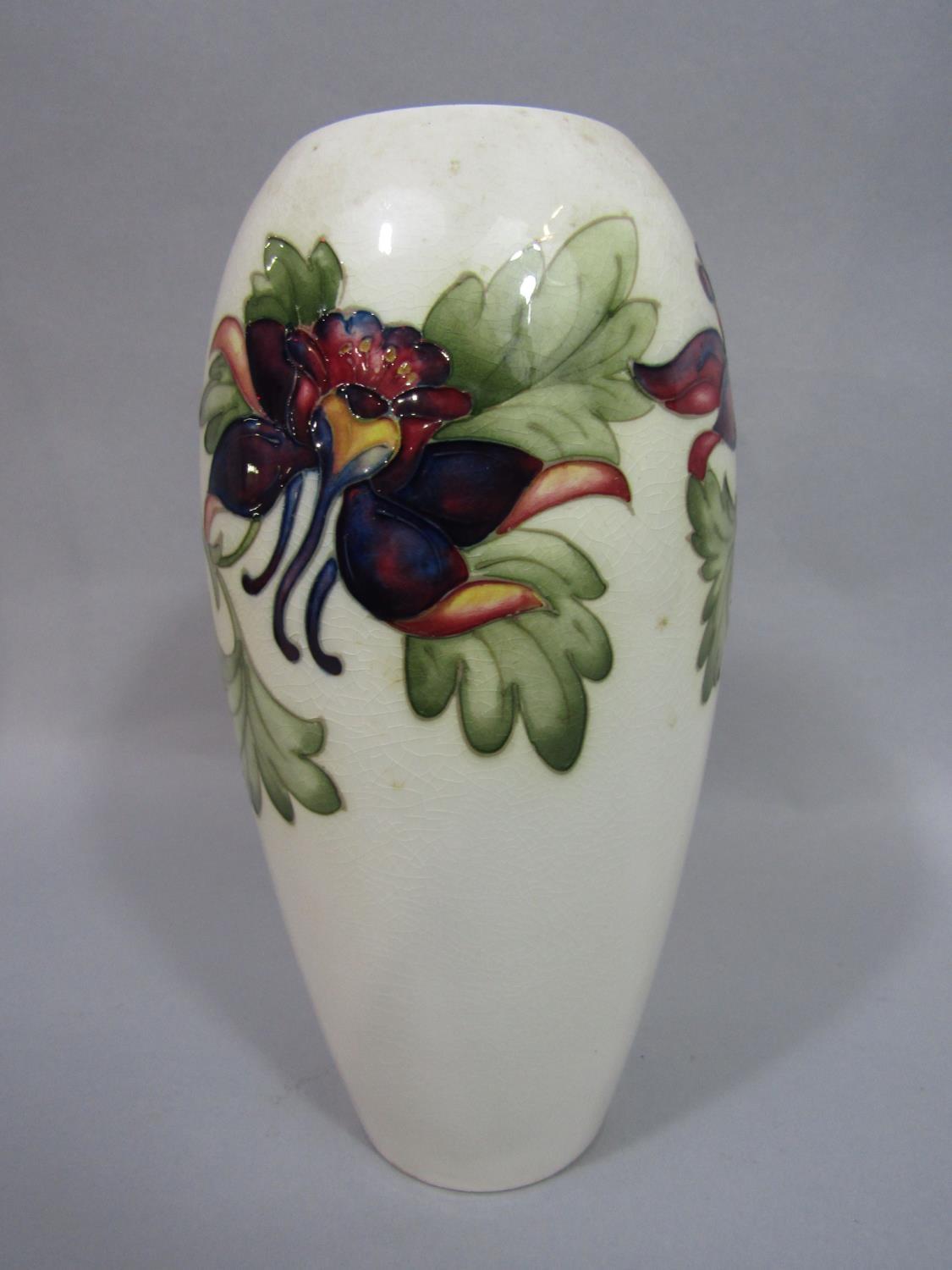 A tall Moorcroft ivory ground vase of ovoid form with painted aquilegia decoration with painted