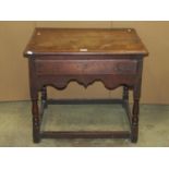 A low Georgian oak side table, the rectangular top with moulded outline over a frieze drawer with