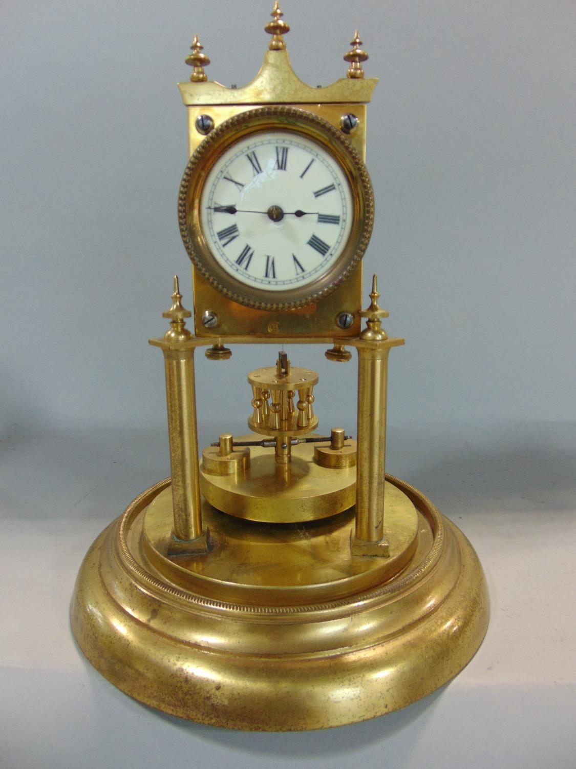 Good quality brass torsion clock with weighted pendulum under a glass ...