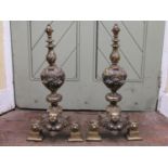 A pair of late 18th century cast brass andirons with repeating fruit, mask and floral detail