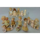 Collection of miniature all bisque dolls, some with jointed limbs and character faces, tallest is