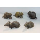 Three good quality Japanese bronze figures of rats, one holding a nut, together with two further