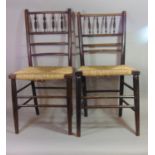 Two similar Arts & Crafts Sussex dining chairs with stained ebonised frames, turned spindle backs