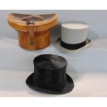 Leather hat box containing brushed silk black top hat by Henry Heath (internal circumference 57cm)