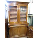 A Victorian mahogany library bookcase, the lower section enclosed by two panelled doors and a