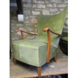 A vintage open armchair with deep sprung upholstered seat and winged button back over shaped arms