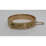 Early 20th century 9ct buckle bangle with engraved foliate decoration, 16.9g (af)