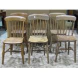 A harlequin set of six Windsor elm and beechwood stick back kitchen chairs with saddle shaped seats