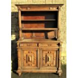 A continental oak two sectional buffet, the lower enclosed by a pair of rectangular raised moulded