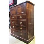 A 19th century mahogany bedroom chest of four long and two short drawers beneath a cupboard enclosed