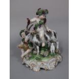 A 19th century continental figure group of a pair of cherubs, one riding on a goat, with a kid