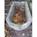 A weathered natural stone trough of rectangular form with single D end and four notched channels,