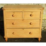 A Victorian stripped pine bedroom chest of two short over two long drawers raised on turned