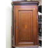 A Georgian hanging corner cupboard, principally in oak, crossbanded in walnut with reeded