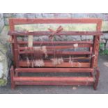 A vintage oak and pine framed loom together with various spools of wool