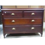 An Edwardian chest of two long and two short drawers beneath a three quarter moulded rail, 115 cm