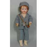 A small bisque head character doll by Eisenmnn, early 20th century, with painted features and