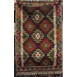 A flat weave Kelim rug with multi geometric detail, set within running borders, 125 x 80cm