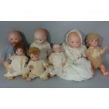 Collection of 6 small German bisque heads dolls with composition bodies including girl and boy