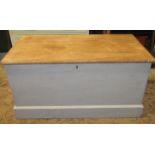 A Victorian pine blanket box with partially painted finish, the hinged lid enclosing a candle box to