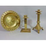 An ecclesiastical brass candle stick with hexagonal stem, one other and an embossed brass gothic