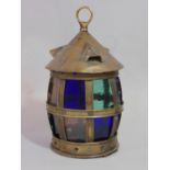 An Arts & Crafts old English style brass lantern with segmented glazed panels beneath a vented