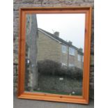 A large contemporary wall mirror with rectangular plate within a cushion moulded pine frame 138 cm x