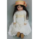 A CM Bergmann Waltershausen bisque headed doll, having fixed brown eyes, open mouth with top teeth
