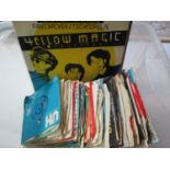 A box containing a quantity of 45 rpm vinyl records, mainly dating from the 60s and 70s to include