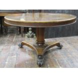 A late Regency rosewood tea table, the circular top 122 cm in diameter raised on a cylindrical