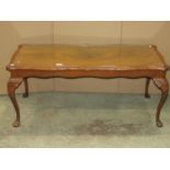 A reproduction walnut veneered side table fitted with a serpentine moulded frieze drawer raised on