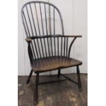 18th century Windsor stick back elbow chair in mixed woods, the elm seat raised on turned supports