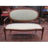 An inlaid Edwardian mahogany parlour room sofa, the oval cameo back with upholstered finish set with