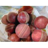 A large collection of vintage red leather cricket balls