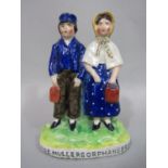 A late 19th century Staffordshire figure group of two children with painted inscription to base
