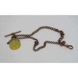 9ct Albert chain with T-bar, hung with a George III 1761 guinea, 38.5g