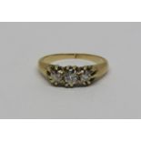 Claw set three stone diamond ring in unmarked yellow metal, size L/M, 3g