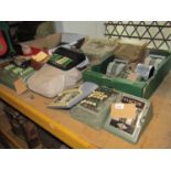A collection of vintage adding machines of varying size and design including Exactus, Summira, Addi,