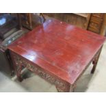 A Chinese stained hardwood centre table (104 cm square) raised on square cut and moulded supports