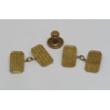 Pair of 9ct engine turned cufflinks, 3.1g and a single yellow metal dress stud (3)