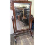 A substantial mid Victorian period mahogany framed cheval glass, the framework incorporating six