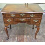 A Georgian walnut lowboy, the quarter veneered top within a crossbanded border over an arrangement