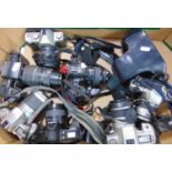 A box of 35mm auto focus SLR cameras to include Nikon, Pentax, Minolta, most with lenses.