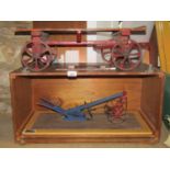 A scale model of a "Turnwrest" ox plough housed within a portable case, together with a further