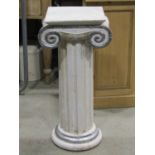 A hardwood pedestal in the form of a doric column with painted and distressed finish, 76 cm high